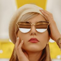 woman wearing gold framed aviator style sunglasses
