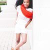 smiling girl in white shirt and shorts wearing red scarf during daytime