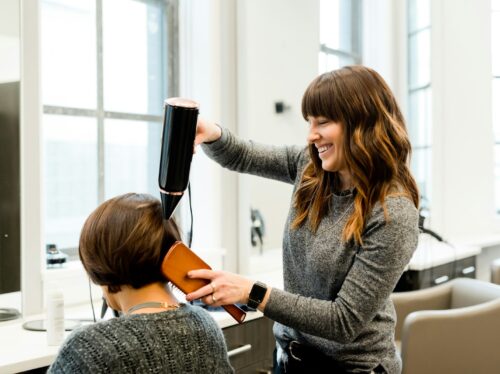woman holding hair dryer