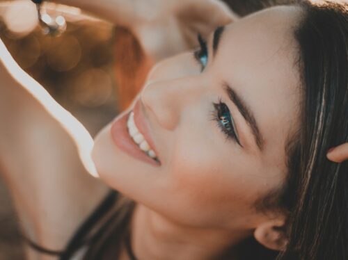smiling woman with black hair and red lipstick